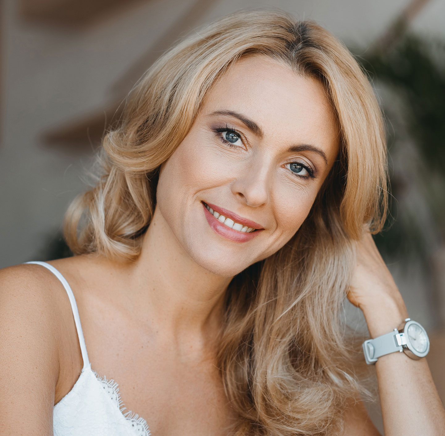 Blonde woman with blue eyes smiling